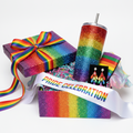 Luxury Pride celebration gift set in a rainbow gift box with tumbler, sash, earrings, and koozie