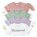Custom bridesmaid graphic tee with rhinestone and glitter role title lettering in dusty rose, sage and lavender