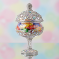 Custom bedazzled stemmed glass candy dish with rhinestone lid, soft pastel background